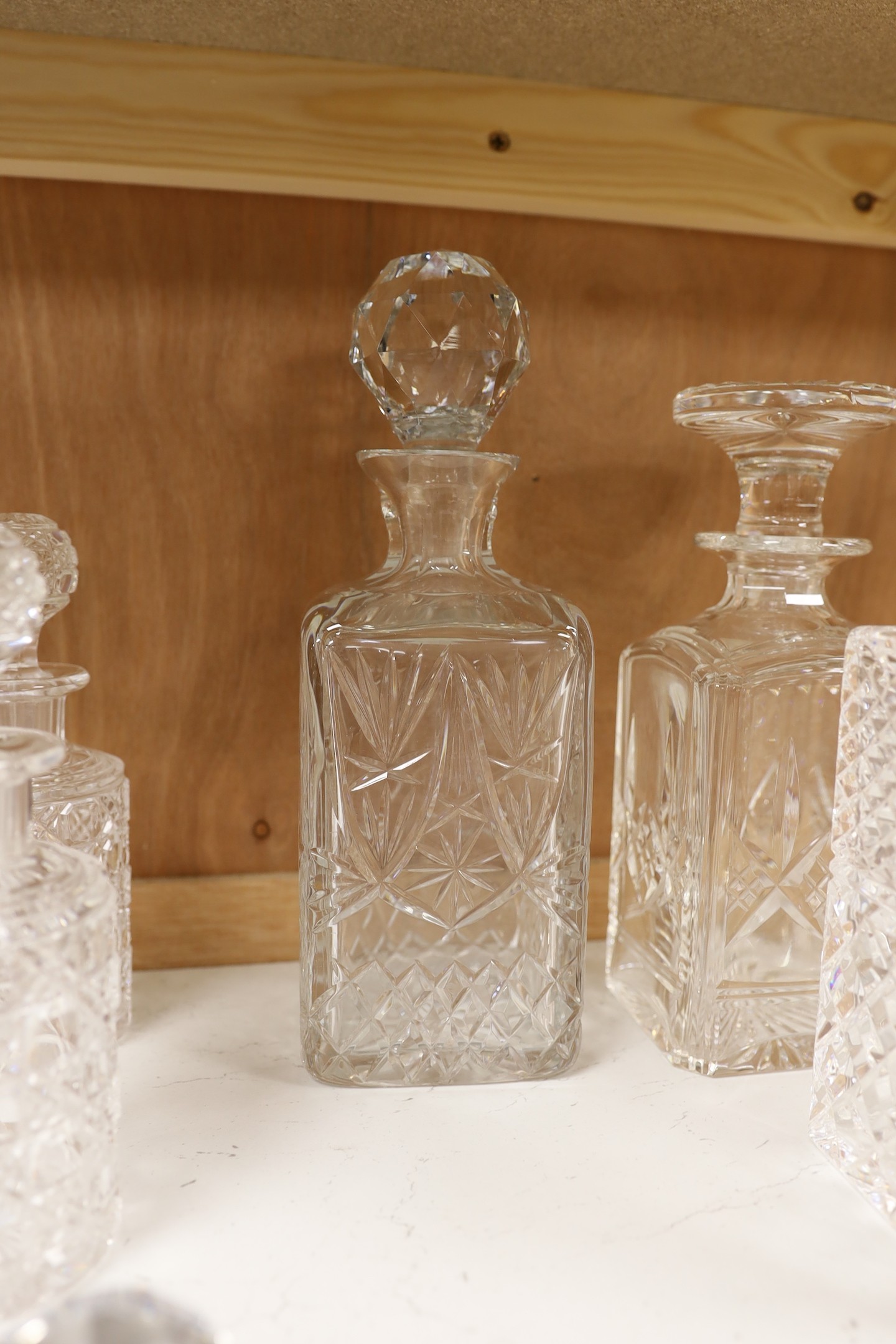 A silver mounted decanter, four others and a smaller pair of decanters, tallest 27.5cm